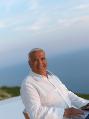 relaxed senior man on balcony