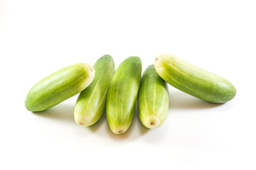 Five green cucumbers in  on white background