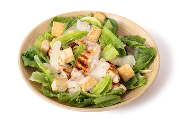 Chicken caesar salad on white background