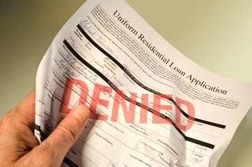 Naklejka premium Denied loan application crumpled in hand