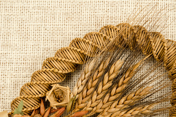 dried grass and barley craft on brownish fabric