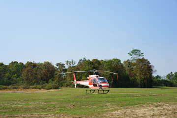 Obraz na płótnie Canvas Helicopter parked at the helipad near forest