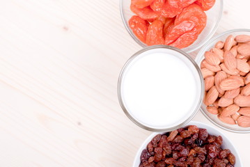 milk, almonds, raisins, dried apricots on the table top view