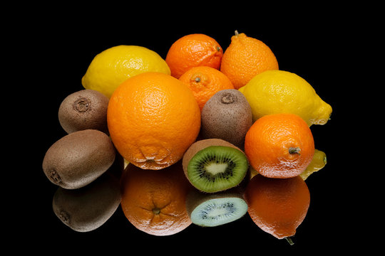 Still life of tropical fruits on a black background