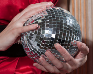 Young woman holding disco ball , close up