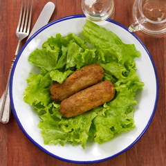 meat croquettes with lettuce on white dish