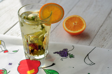 Herbal tea with orange and ginger in glass
