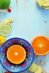 Various citrus fruits and ginger on blue cutting board