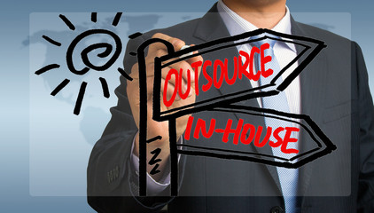 outsource or in-house signpost hand drawing by businessman