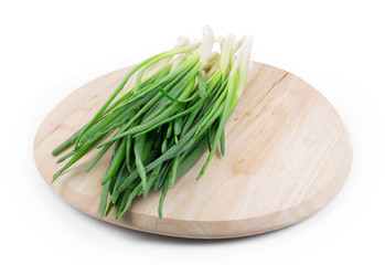 Green onion on a wooden board.