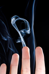 Smoking fingers on black background