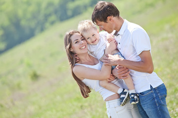 Family playing with son in the flowers field