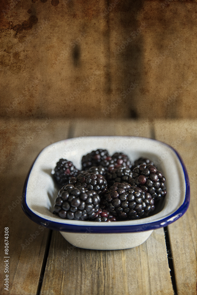 Wall mural blackberries in rustic kitchen setting with wooden background wi