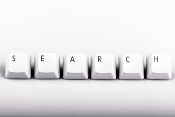 text search formed with computer keyboard keys on white backgrou