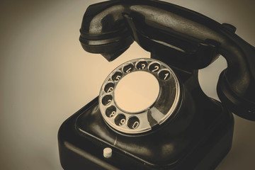 Old black phone with dust and scratches on white background