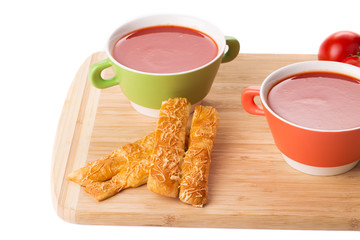 Bowl of tomato soup on a white background.