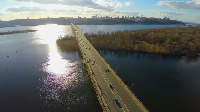 Bright sunny day in big city, transport bridge across river