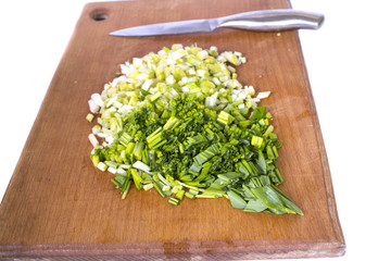young green forest leaves of wild garlic sliced on a cutting boa