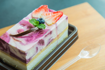 Blue berry cheese cake on wooden plate