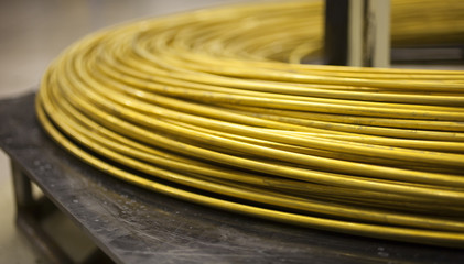 Pile of thick brass wire waiting to be made into casings for ammunition
