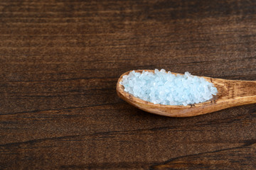 Fototapeta na wymiar closeup bath salts in wood spoon