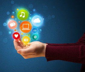 Multimedia icons in the hand of a woman