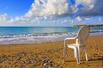 white armchair on a beach