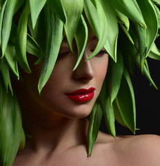 Beauty Spring or Woman with Fresh green leaves hair. Summer Natu