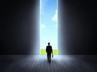 businessman walking to open gate
