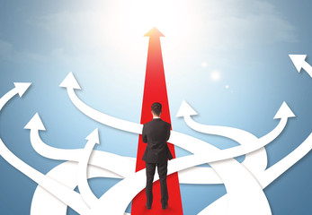 businessman with different direction arrows