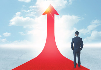 businessman standing on a red arrow