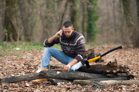 Young lumberman talking on the mobile phone