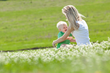 Fototapeta premium Mother with son are playing in nature