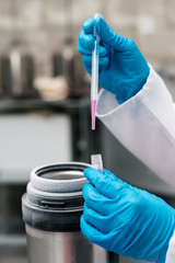 Scientist holding tube with suspension of stem cells