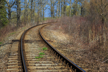 Fototapeta na wymiar Scenic railroad in spring in remote rural area -selective blur