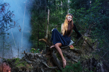 Naklejka premium beautiful witch in forest