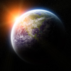 Sunrise over planet Earth in space