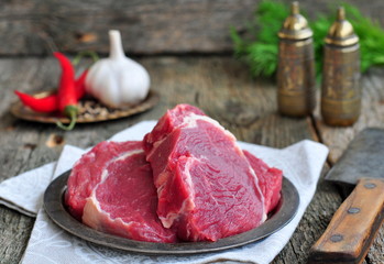 Juicy raw beef steak on wooden table