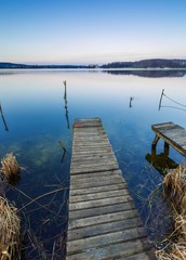 Lake landscape with small wooden pier