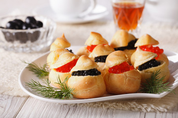 profiteroles stuffed with red and black caviar, horizontal