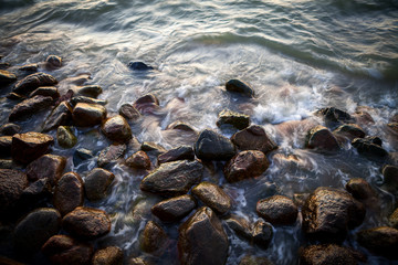 Beautiful granite stones into the sea at sunset