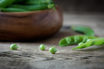 green peas in wooden bowl