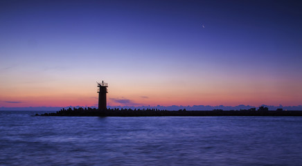 Fototapeta premium Lighthouse on sunset.dramatic sky lights