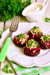 Canape from fried rye bread with beetroot,carron,garlic and chee