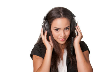 Naklejka premium Young brunette lady listening to headphones, on white