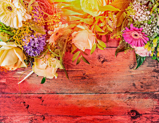 Summer flowers on red wooden background