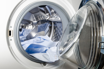washing machine loaded with blue shirt