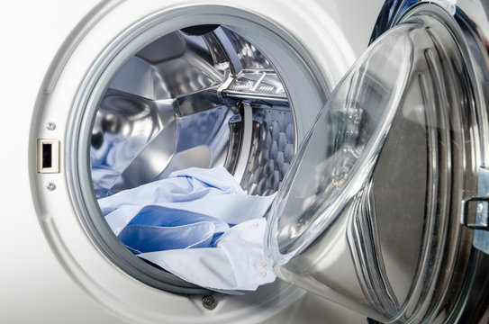 Washing Machine Loaded With Blue Shirt