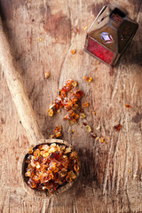 Gum arabic, also known as acacia gum - in  old wooden spoon