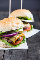 closeup pub style burger on wooden table